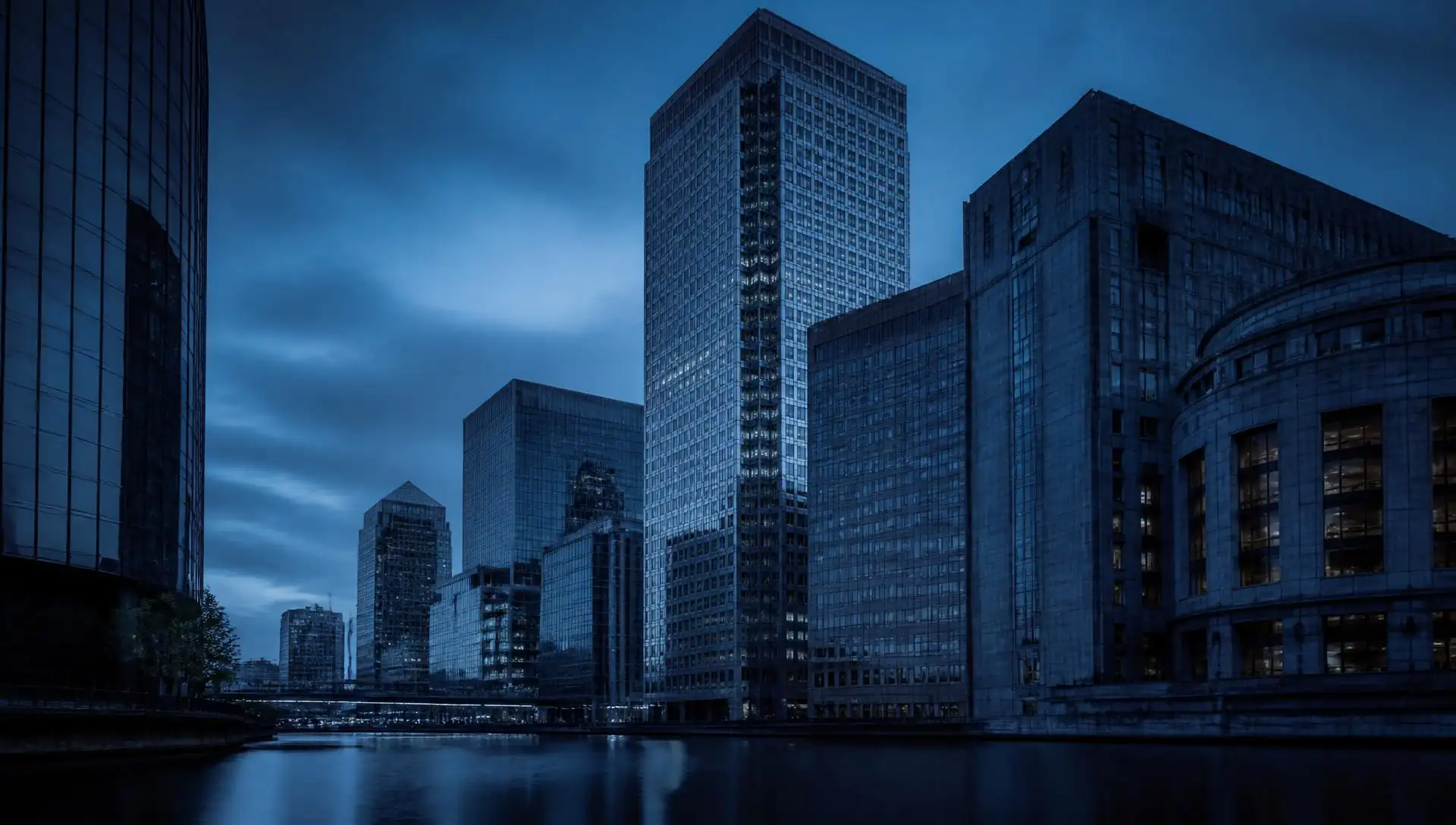 Global financial district skyline at dusk, seen from the water