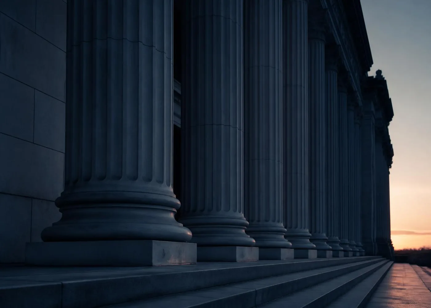 Classical institutional stone architecture lit at dawn